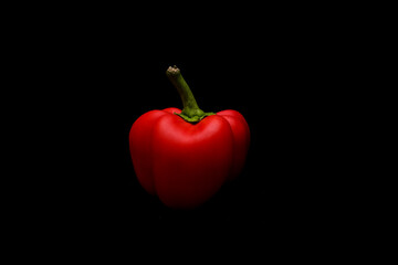 Red bell pepper on black background