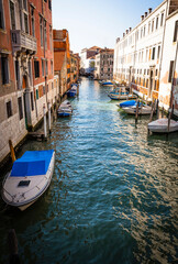 Fototapeta na wymiar Boats and ancient houses in the channels of Venice, Venetian, Italy