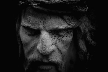 Fototapeta na wymiar Very ancient partially broken stone statue of Jesus Christ crown of thorns.