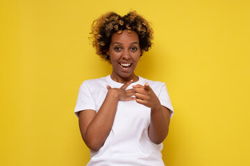 Beautiful african woman laughing at you, pointing finger to the camera. Great joke concept.