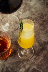 citrus cocktail with ice and fresh rosemary.