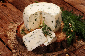 Cheese platter of tomatoes and herbs on a wooden table