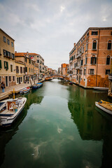 Boats and ancient houses in the channels of Venice, Venetian, Italy