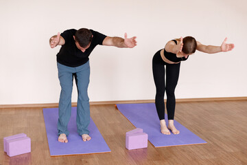 Fototapeta premium Couple yoga in the studio