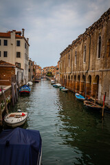 Boats and ancient houses in the channels of Venice, Venetian, Italy