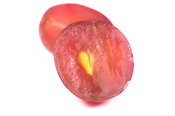 Purple ripe grapes cut in half on the white background. Close up photo. Ecological fruit for vegans. Vitamins.
