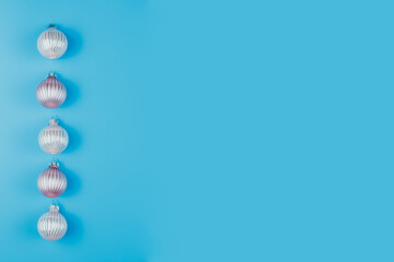 Christmas or New Years minimalistic background, with Christmas balls on blue.