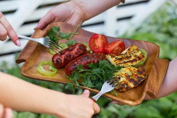 Sausages and cheese, grilled with vegetables