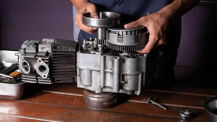 Part of motorcycle engine on a table in workshop