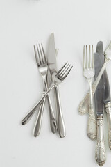 Silver or steel cutlery view from above on a white background. Top view..Knife and fork for a festive table for a wedding, birthday or party.