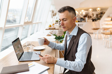 Confident handsome businessman in smart clothes