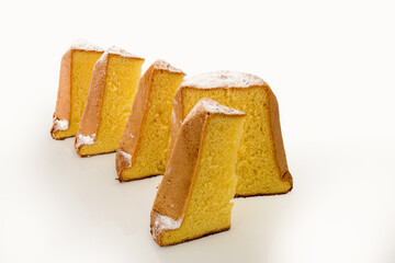 Pandoro, typical Italian Christmas dessert, cake cut with slices with powdered sugar isolated on white
