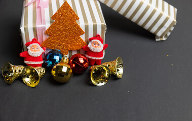 Christmas Decoration, Santa Claus with balls and gifts isolated on Black background. Concept photo for christmas greetings and celebrations.