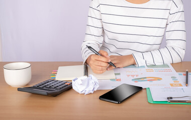 Close up accountant auditing accounting reports, profit and loss data, analytical graph marketing...