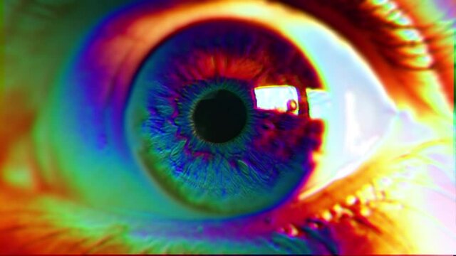 Psychedelic Eye Color Spectrum Glitch. Extreme close up of an wide opened eye in a psychedelic effect. Color spectrum effect