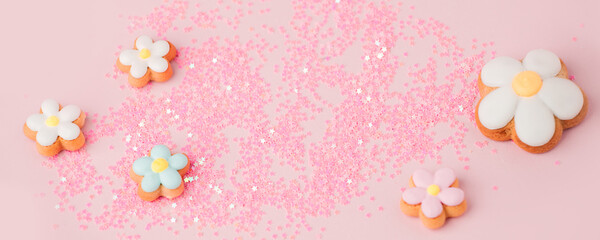 Flower shape cookies anf confettic on pink pastel background. Tender holiday concept - Saint...