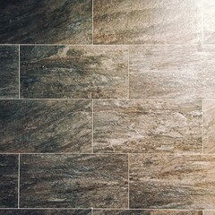 Natural stone texture. Ceramic tile. Rectangular blocks with seams.