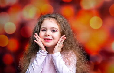 Portrait of happy smiling child girl on colored background. Laughing people.