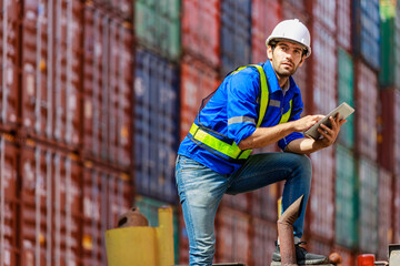 smart&young engineer in protective work wear in shipping yard examining cargo