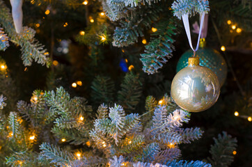Obraz na płótnie Canvas Christmas balls of on a blurred background, decorated with a silver branch.