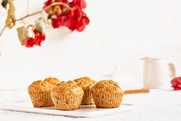 Homemade muffins with ginger and nuts on white table. Healthy eating, gluten free.Homemade tasty dessert or breakfast for Valentine's day,Mother's day