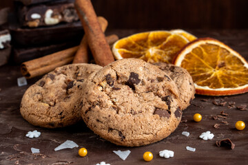 Organic food snack tasty sweet dessert milk dark chocolate chip salt cookie closeup piece fruit orange raspberry hazelnut nuts cinnamon on cocoa cacao powder wooden table for new year Christmas gift