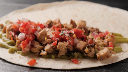 Cooking quesadilla close-up on a black background. Step by step food preparation.
