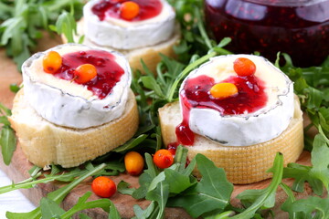 Cheese Saint-Mor-de-Touren with a glass of red wine on a white wooden background