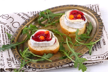 Cheese Saint-Mor-de-Touren with a glass of red wine on a white wooden background