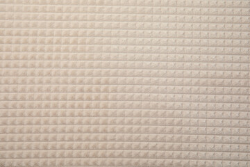 Soft warm white plaid as background, closeup