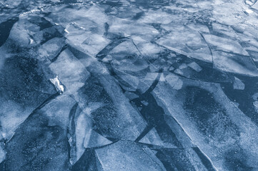 Cracked ice on a river in winter