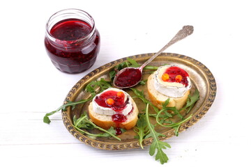 Cheese Saint-Mor-de-Touren with a glass of red wine on a white wooden background