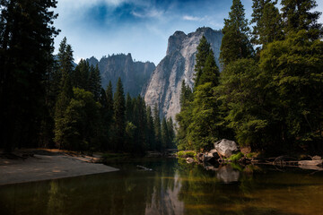 Scenic view of the merced river in the Yosemite valley, with the rocky mountains reflected on the water, in California, USA.