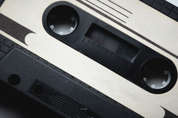 Close-up of a classic audio cassette tape with magnetic tape inside. Retro background