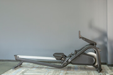 Rowing machine in the crossfit gym. Sports and active lifestyle. Gray background. Space for text.