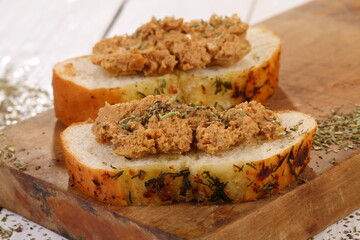 Norwegian cheese brunost on white wooden table