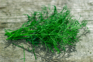 Fresh green dill on wooden table. Top view. Healthy food background.