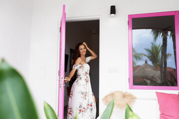 Fototapeta premium A girl in a beautiful summer dress with a hat.