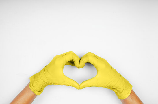 Hands in heart-shaped medecine gloves