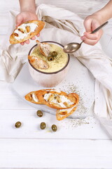 French puree soup with parsnip, soft cheese baguette. Holds a soft cheese sandwich