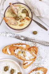 French puree soup with parsnip, soft cheese baguette. Holds a soft cheese sandwich