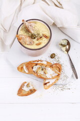 French puree soup with parsnip, soft cheese baguette. Holds a soft cheese sandwich