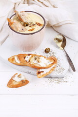 French puree soup with parsnip, soft cheese baguette. Holds a soft cheese sandwich
