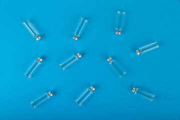 vaccine vials are on blue medical background top view