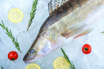 raw fish is on ice cubes. poster with chilled raw fish with ice top view