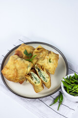 Martabak telur mini, Indonesian street food. fried wrap filled with eggs, minced meat, and vegetables.