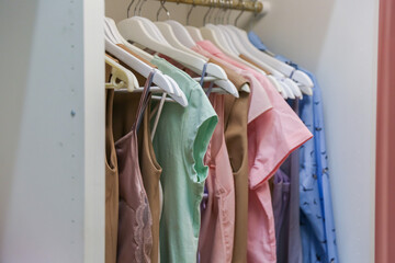 hangers with women's dresses and other colorful clothes