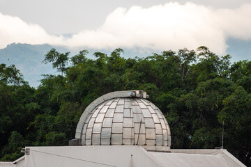 Obraz premium Dome on a Roof Similar to an Observatory Surrounded of Trees