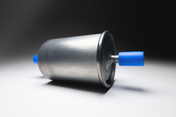 New fuel filter for gasoline internal combustion engine with blue caps on a gray background. New...