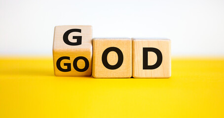 God is good symbol. Turned a cube with words 'God is good'. Beautiful yellow table. White background. Religion and God is good concept.
